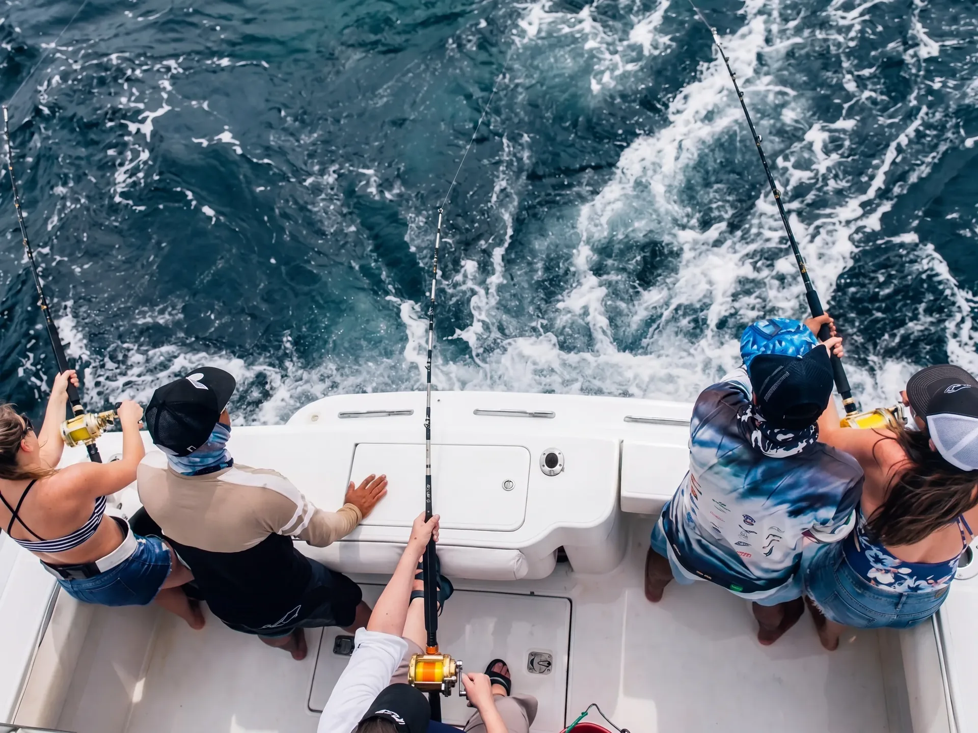 Anglers trolling from the stern of a fishing charter in the Gulf of Papagayo, Costa Rica, seen from above