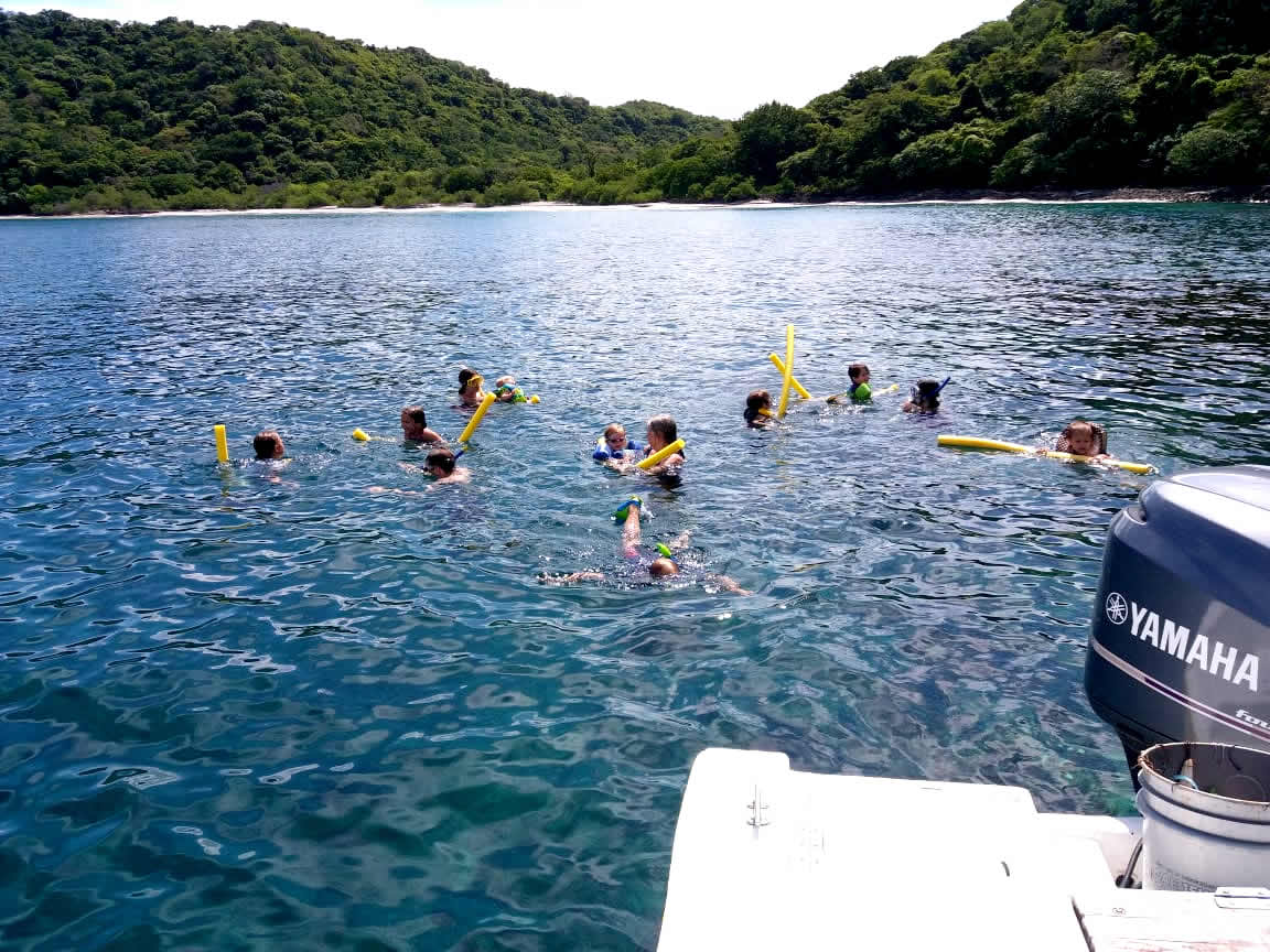 Family snorkeling from a charter boat in the Gulf of Papagayo, Costa Rica