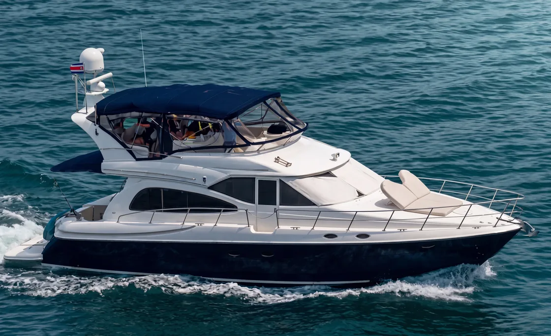 Luxury yacht underway with guests aboard, Costa Rican flag flying
